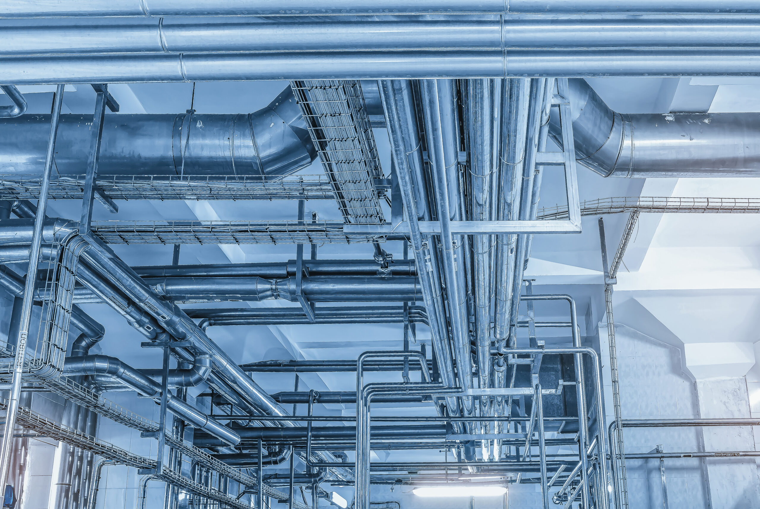 Metal pipes under the ceiling of the milk production plant